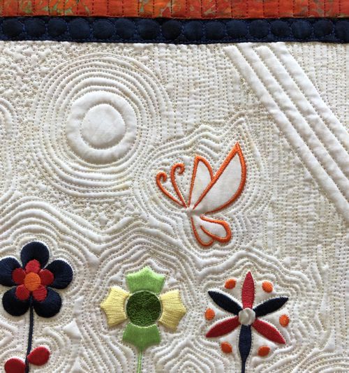 Close-up of the quilting pattern and embroidery.