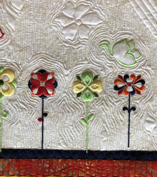 Close-up of the quilting pattern and embroidery.