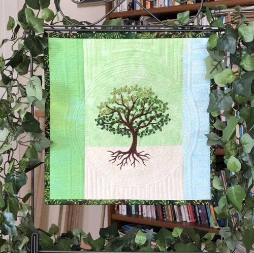 Early summer day quilt in light green hues.