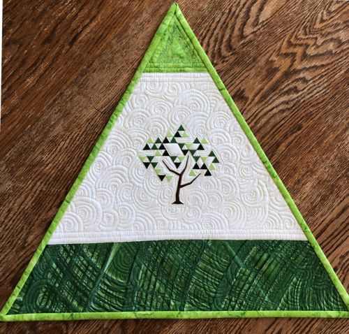 A close-up of a placemat with a tree embroidery