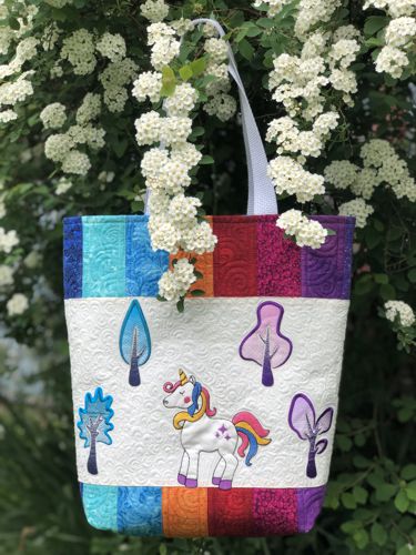 Finished tote bag with the unicorn and trees embroidery.