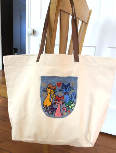 A canvas marker tote with an embroidered pocket