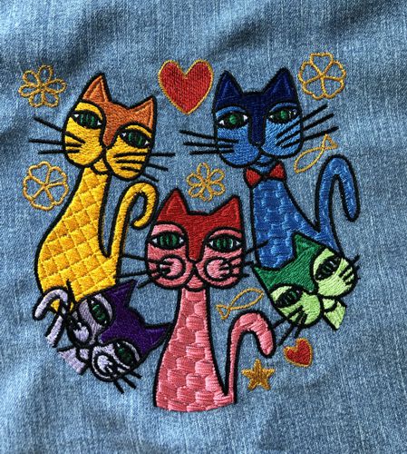 A stitch-out of onw of the designs from the set with cats in different colors.