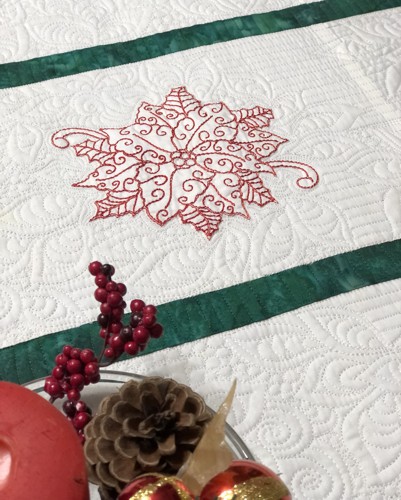 Close-up of the stitch-out of one-color poinsettia and quilting stitches