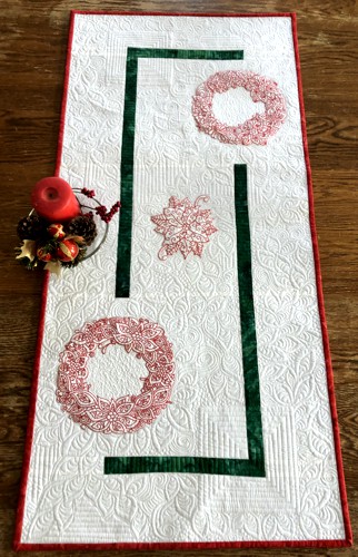 Finished runner with red embroidery of poinsettia and holly wreaths