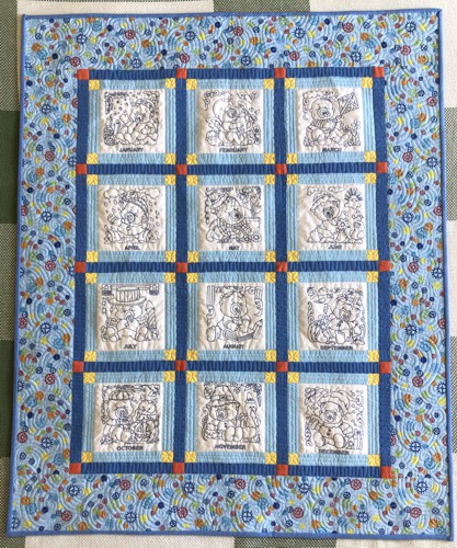 Blue-and-white baby quilt: 12 blocks with embroidery