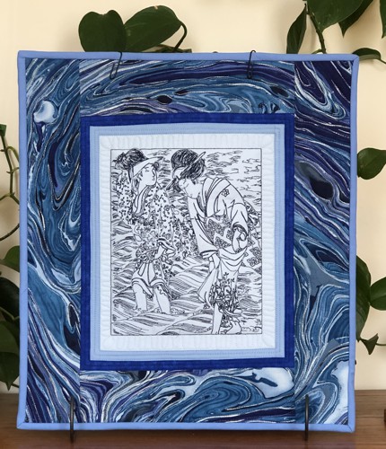 Small quilt in blue hues with one-color embroidery of a Japanese picture of women by the sea.