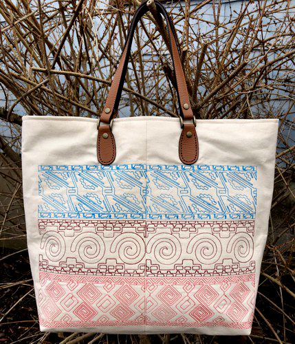 The finished canvas tote bag with Mexican motif embroidery on the front and back panels.