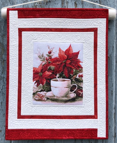 Small red-and-white wall quilt with embroidery of poinsettia and a cup of coffee.