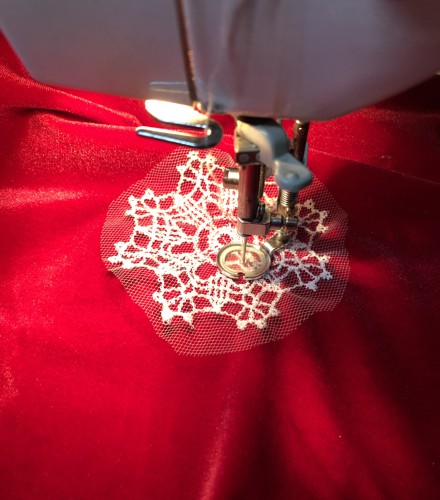A snowflake stitch-out stiched to the dress with the quilting foot in a free motion style.