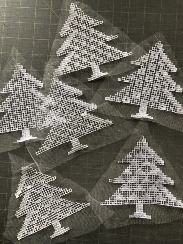 Stitch-outs of fir trees on the net.