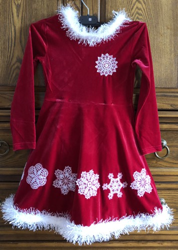 Red child's dress embellished with snowflake embroidery.