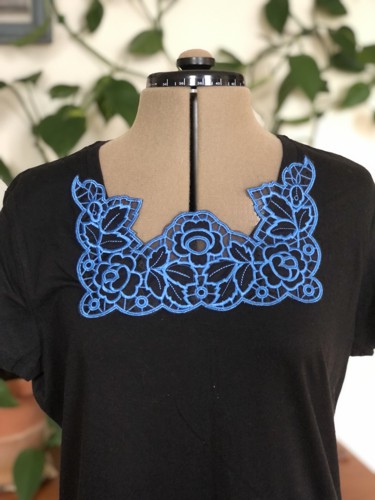 A black T-shirt with the blue cutwork embroidery