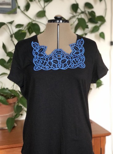 A black T-shirt with cutwork embroidery around the neckline