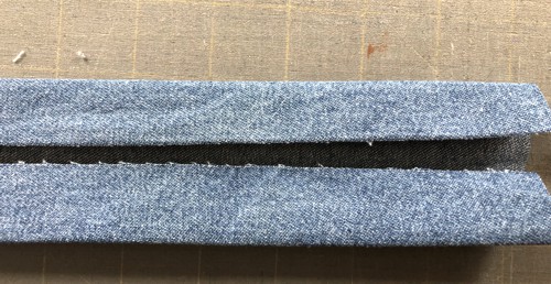 The fabric strip is folded lengthwise in half.