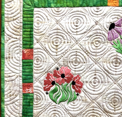 A close-up of the embroidery and quilting stitches.