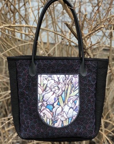 The finished tote bag with iris embroidery on the front pocket