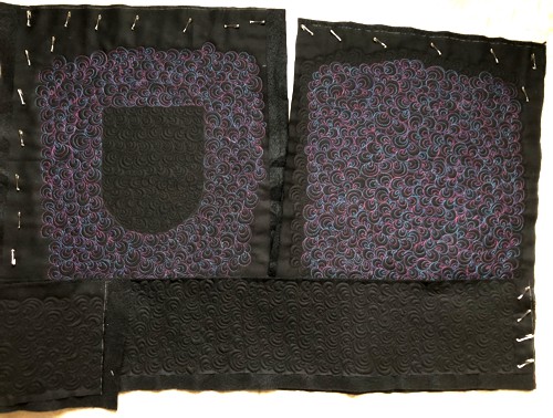 The quilted parts of the tote bag.