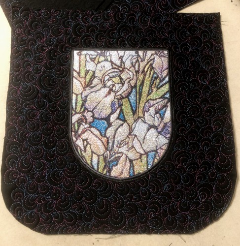 The embroidered pocket is stitched to the front panel.