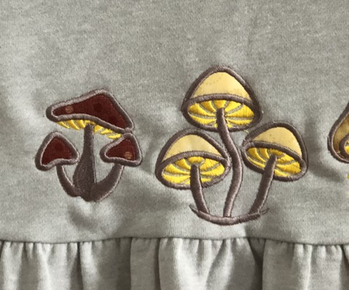Stitch-outs of 2 applique mushrooms.