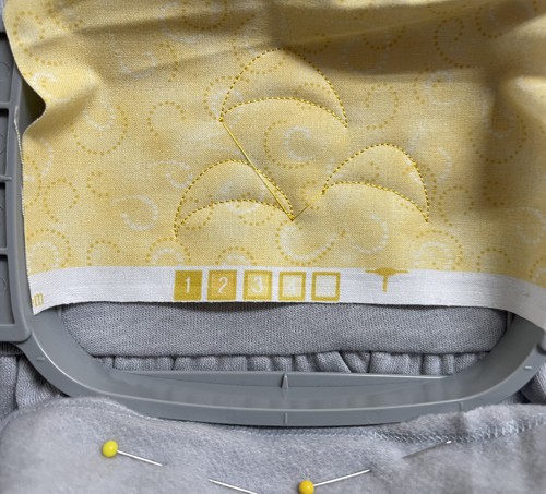 The second colors embroiders the same outline over the applique fabric.