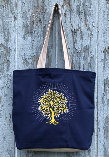 Finished tote bag with embroidery of a tree on the front panel.