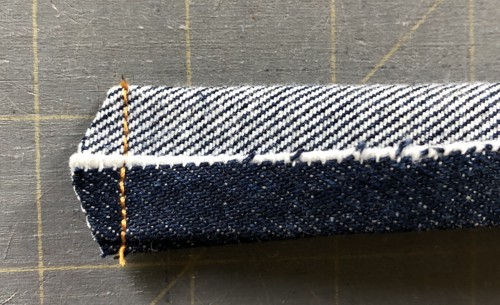 Stitch with seam allowance 1/4" along the short edges. Trim the corners.