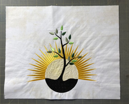 A stitch-out of the sunrise tree design.