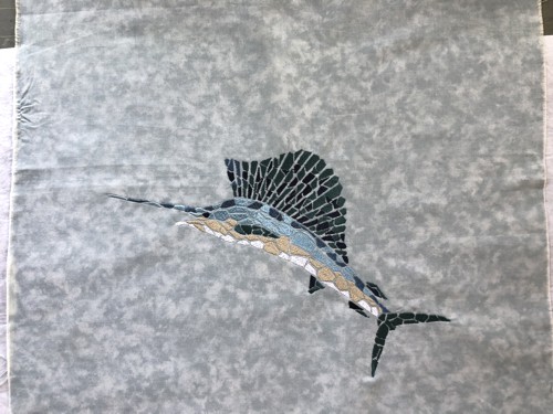 A stitch-out of the design of Swordfish on a grey background