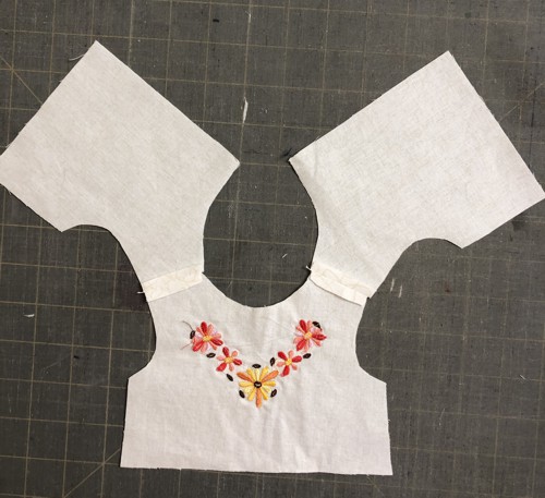 The top and its lining stitched at shoulders.