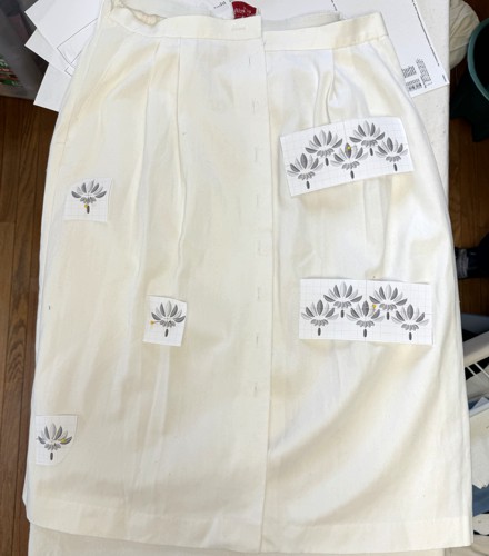 The skirt with embroidery print-outs to show the placement of the embroidery