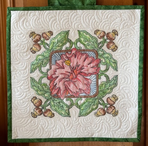 A quilted tile with hibiscus embroidery