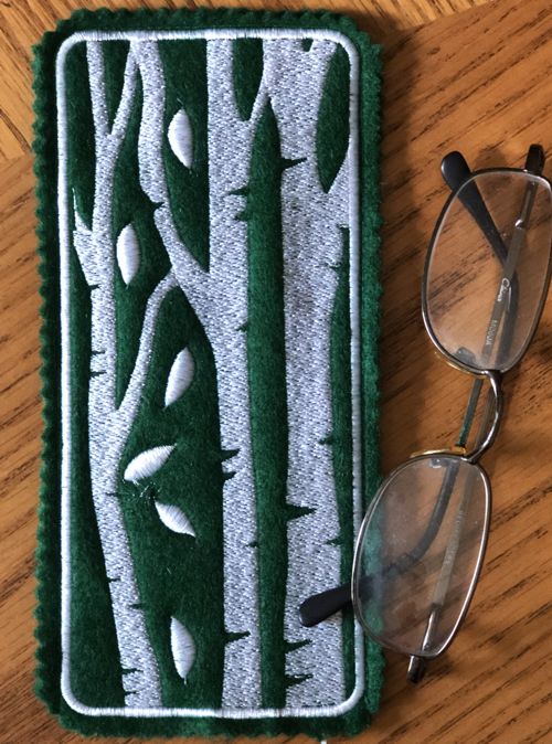 Finished glasscase with one-color birch treee embroidery on the back panel