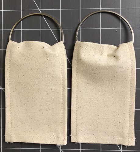 Put through the rings, fold aligning the short ends. Topstitch the short ends together.