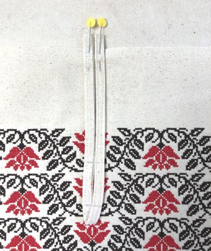 Pin the button loop over the mark.