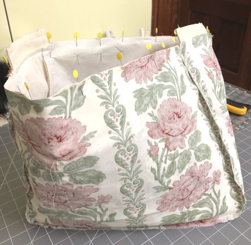 With right sides together, insert the outer bag into the lining. Align and pin together all seams and upper edges.