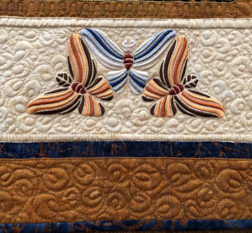 A close-up of the embroidery and quilting stitches on a border.