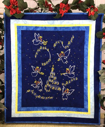 Finished wall quilt with embroidery of Caroling angels and music on a dark blue background with light blue and yellow borders.