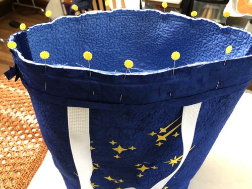 The blue strip is pinned to the upper edge of the bag.