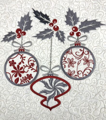 Stitch-outs of the Christmas ornaments in gray and red colors.