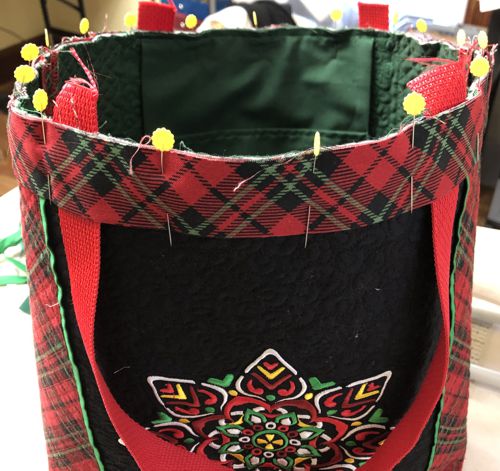 The folded strip is pinned to the upper edge of the bag.