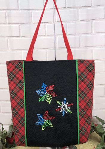 Finished tote bag with embroidery of small multicolored snowflakes on the back panel
