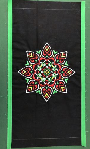 The green strips sewn to the long edges of the front panel.