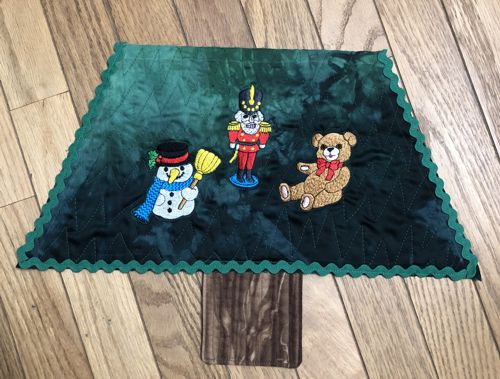 Topstitch the large rick-rack trim along the side and lower edges of the first level.