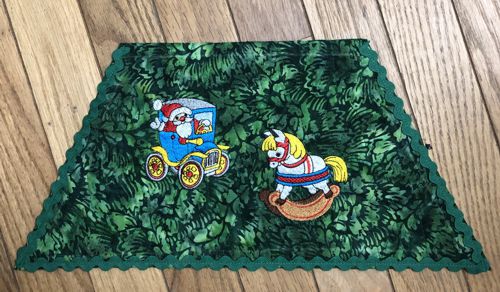 Topstitch the large rick-rack trim along the side and lower edges of the second level.