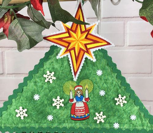 Upper level of the tree decorated with snowflake buttons.