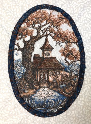 Bias strip basted around the embroidery.