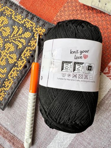 Embroidered square and polyester cord.