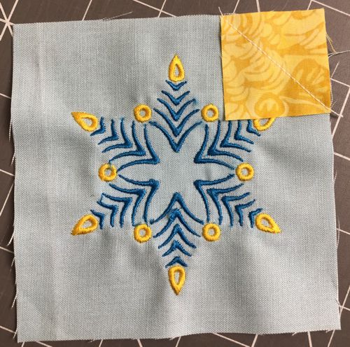 Stitch along the diagonal from corner to the opposite corner of the square.