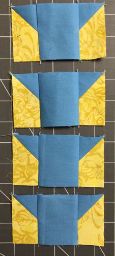 Stitch the 2-color units to the left and right edges of the 2 1/2" x 2 1/2" blue squares.